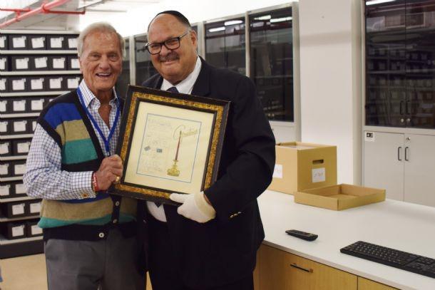 Singer &amp; songwriter Pat Boone (left) with Mr. Shaya Ben Yehuda, Director of the International Relations Division at Yad Vashem, during his visit to the Yad Vashem archives on 11th May, 2018 holding Boone’s original lyrics of his most famous song “Exodus&quot;